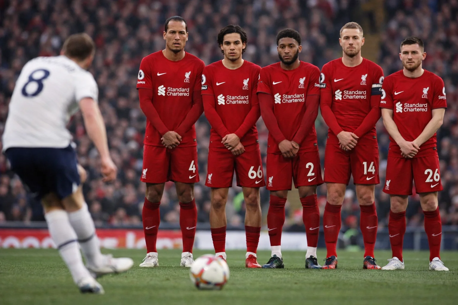 Football players forming a defensive wall during a free kick