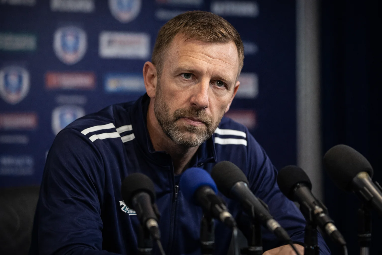 Football manager speaking at a press conference before a cup match
