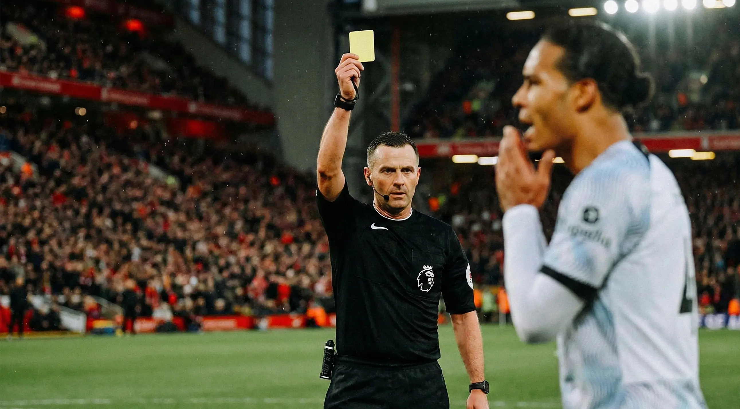 Football referee showing a yellow card during a match under stadium lights