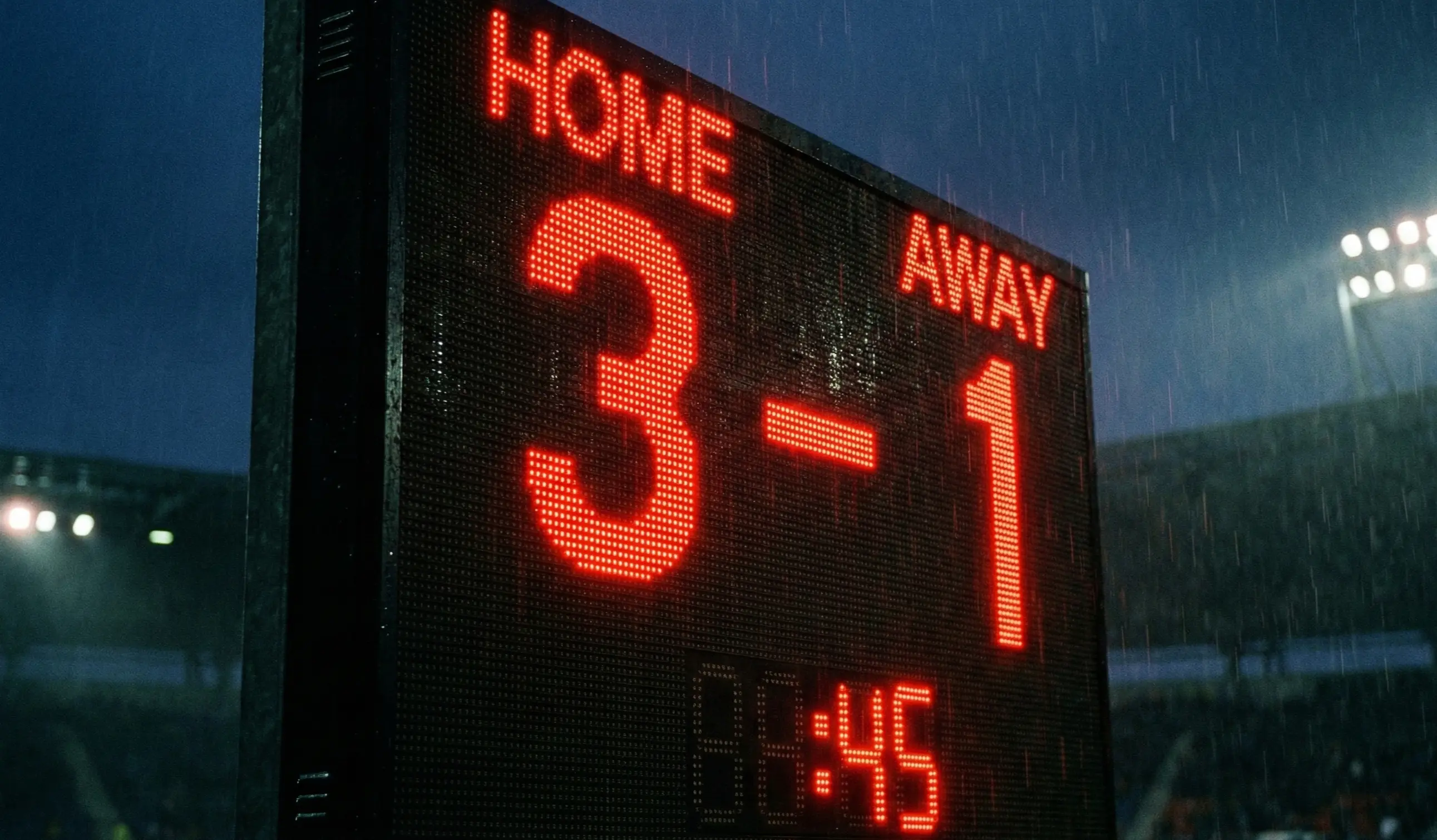 Stadium scoreboard showing a football match score with visible goal difference